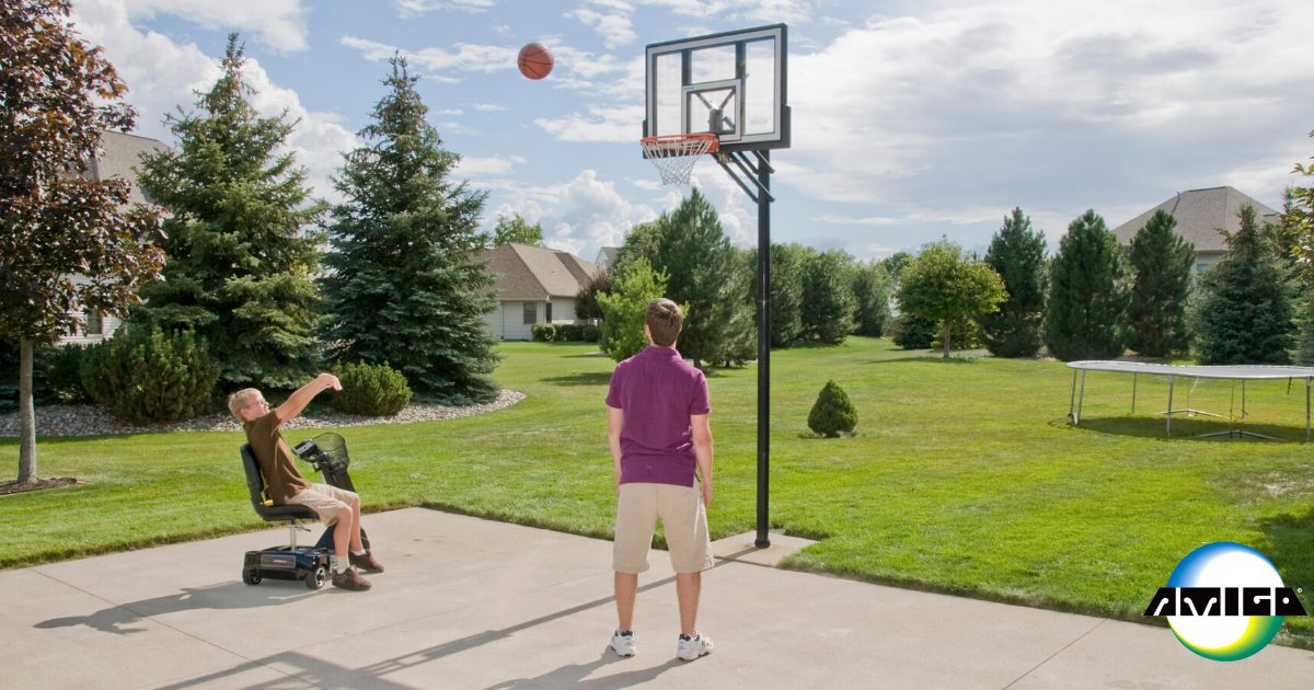 Young male amigo user and brother playing basketball