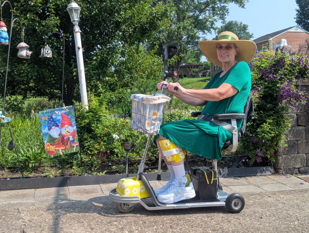 Mary Murphy posing on her 1980s model Amigo scooter.